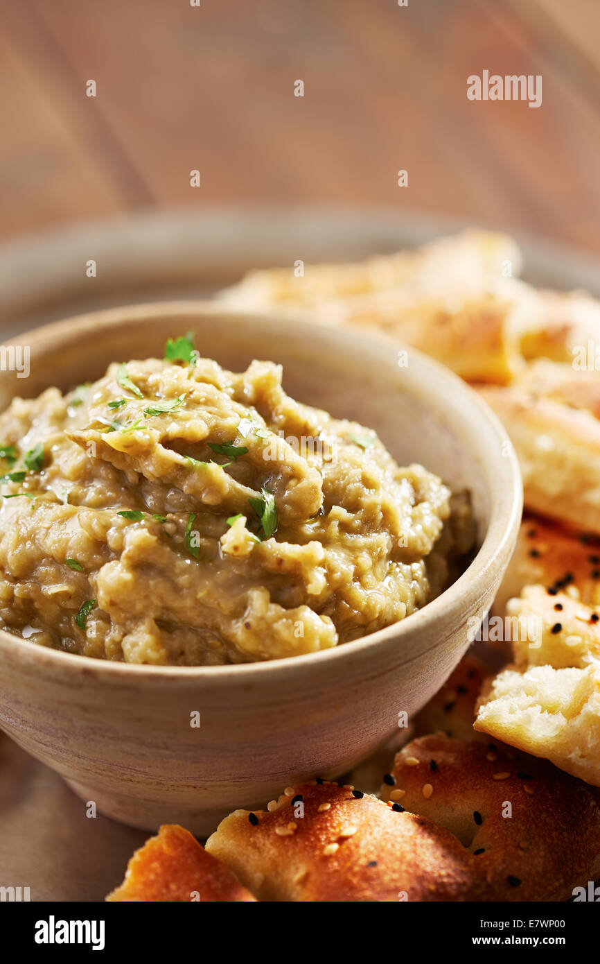 Eggplant baba ganoush with flat bread and herbs Stock Photo