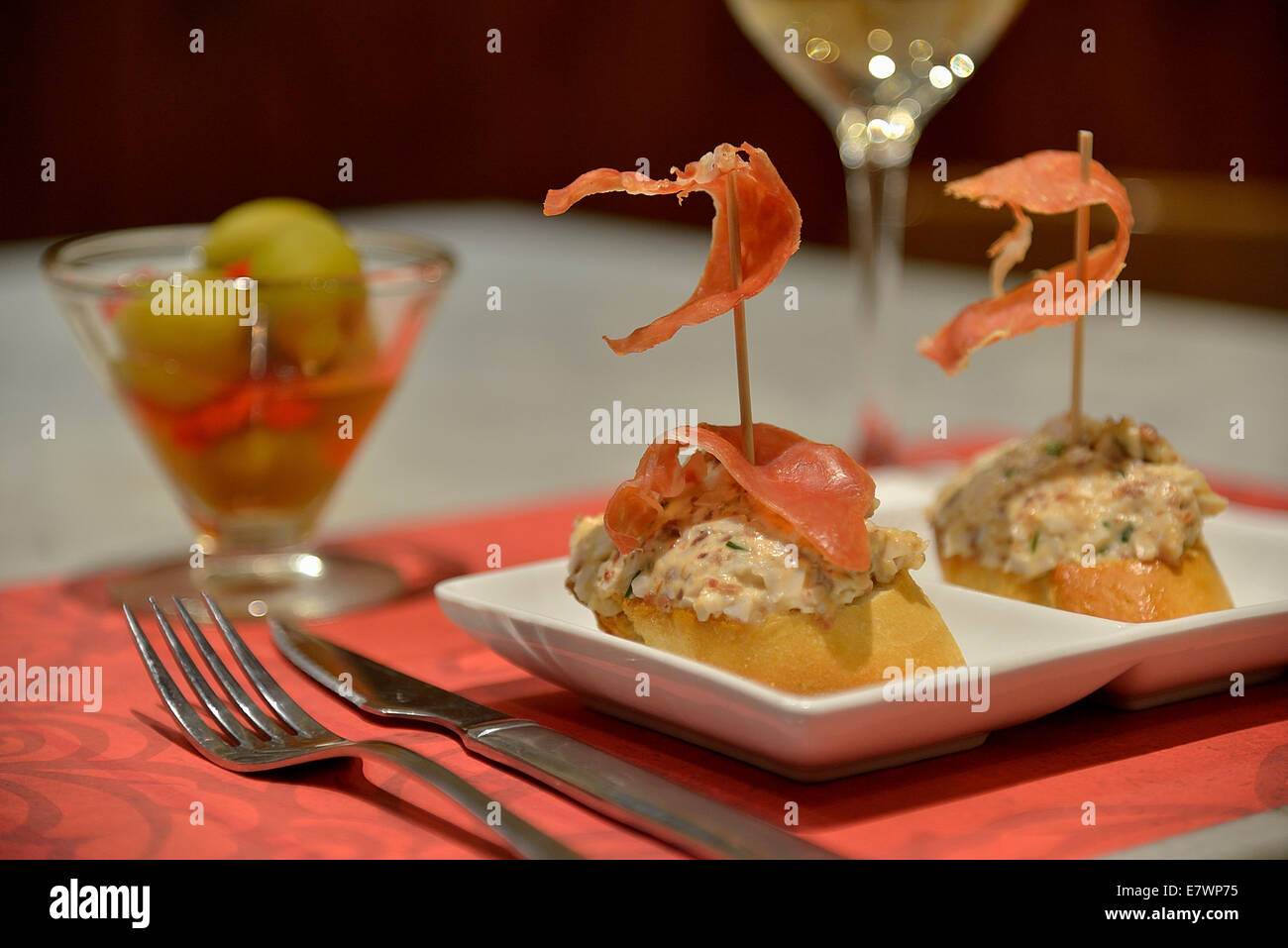 Russian salad with Iberico ham on white bread in a tapas bar, Palma, Mallorca, Balearic Islands, Spain Stock Photo