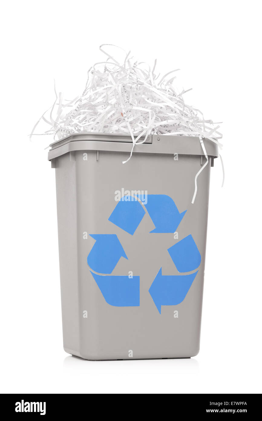 Recycle bin full of shredded paper isolated on white background Stock