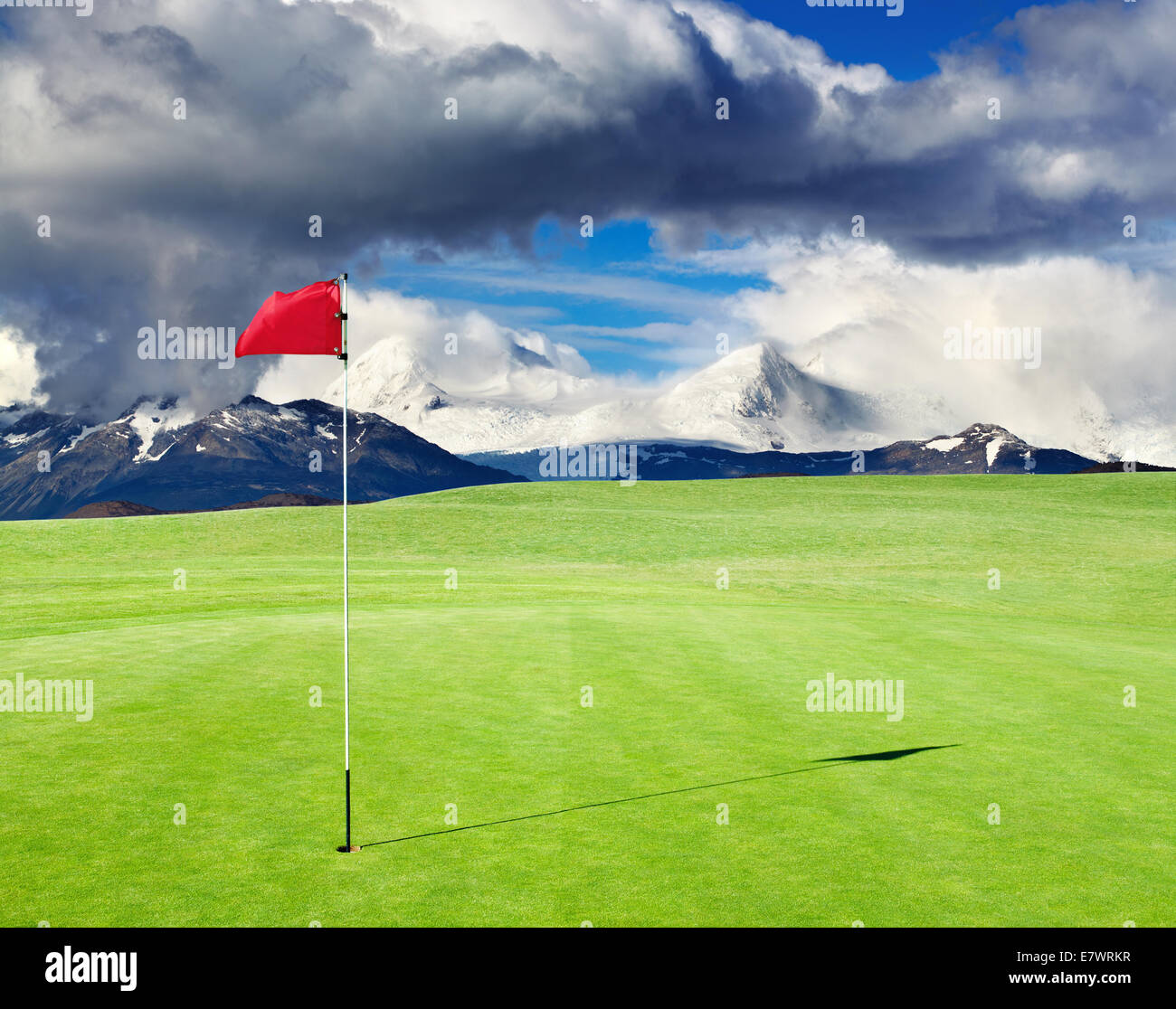 Golf field with red flag in the hole Stock Photo