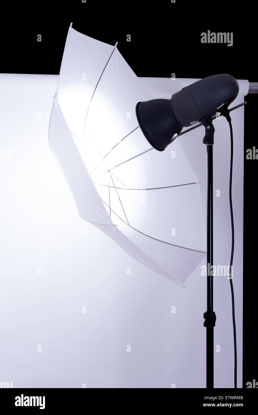 Empty photo studio with white background and lighting on dark Stock