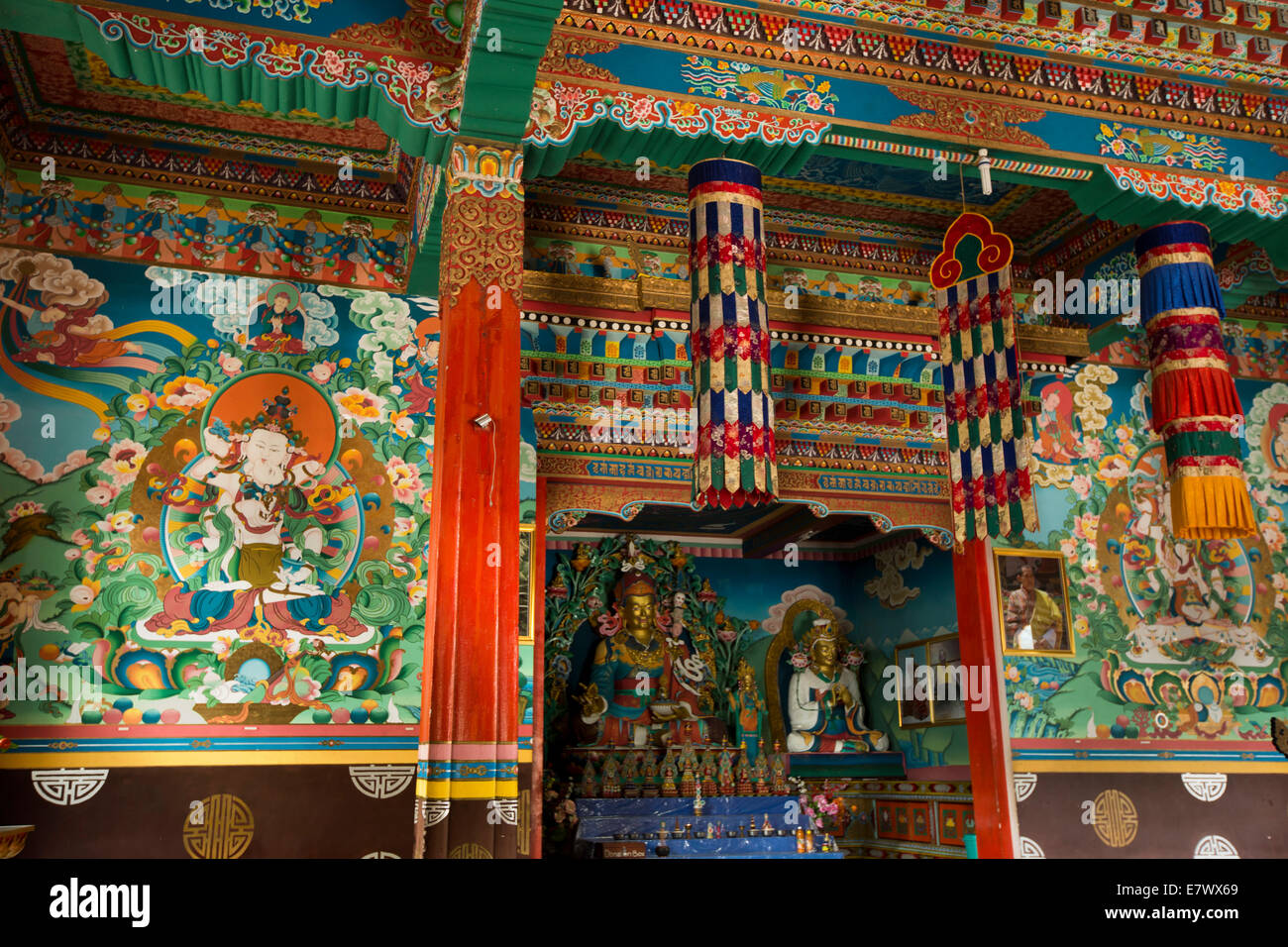 Eastern Bhutan, Trashigang, Rangjung Woesel Choeling Monastery interior, altar and decorated walls Stock Photo