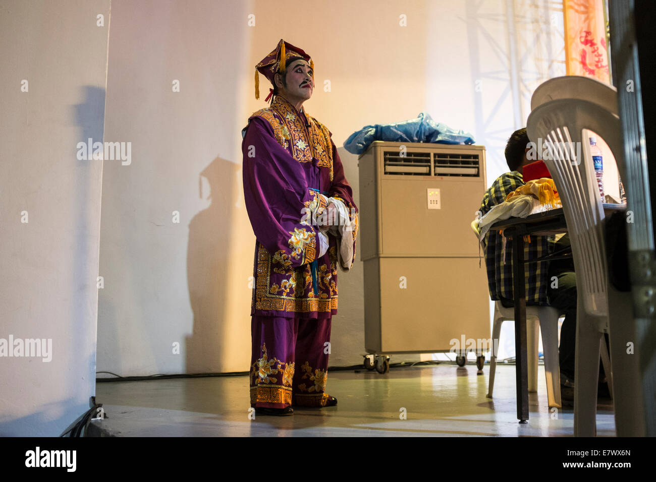 A Chinese Opera performer waits off stage during a free performance in Hong Lim Park in Singapore Stock Photo
