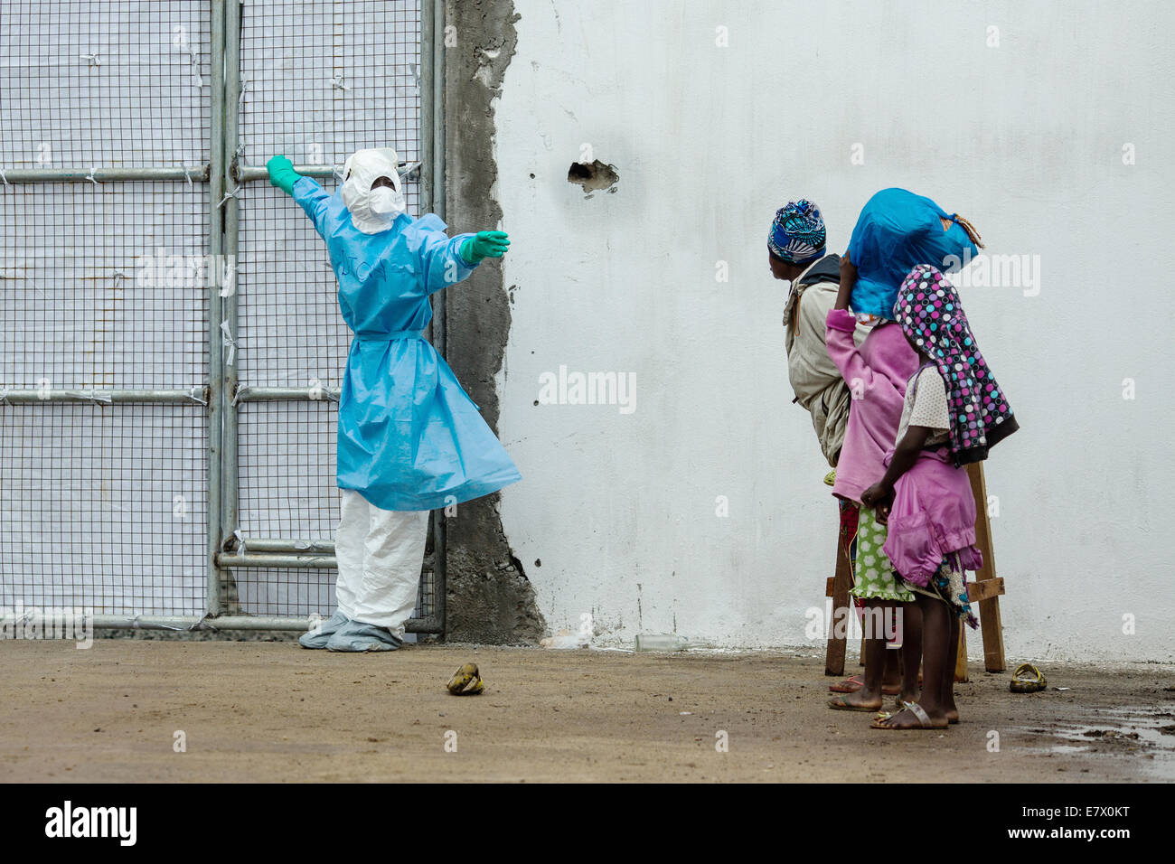 A family waits to enter the newly opened Island Clinic for Ebola treatment September 22, 2014 in Monrovia, Liberia. The facility opened by the WHO and the Ministry of Health in response to the surge of patients needing an Ebola Treatment. Stock Photo