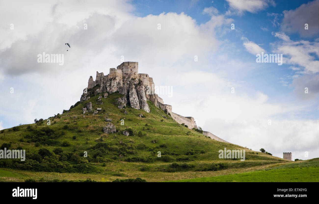 A hangglider flying over Spis Castle, Slovakia. Stock Photo