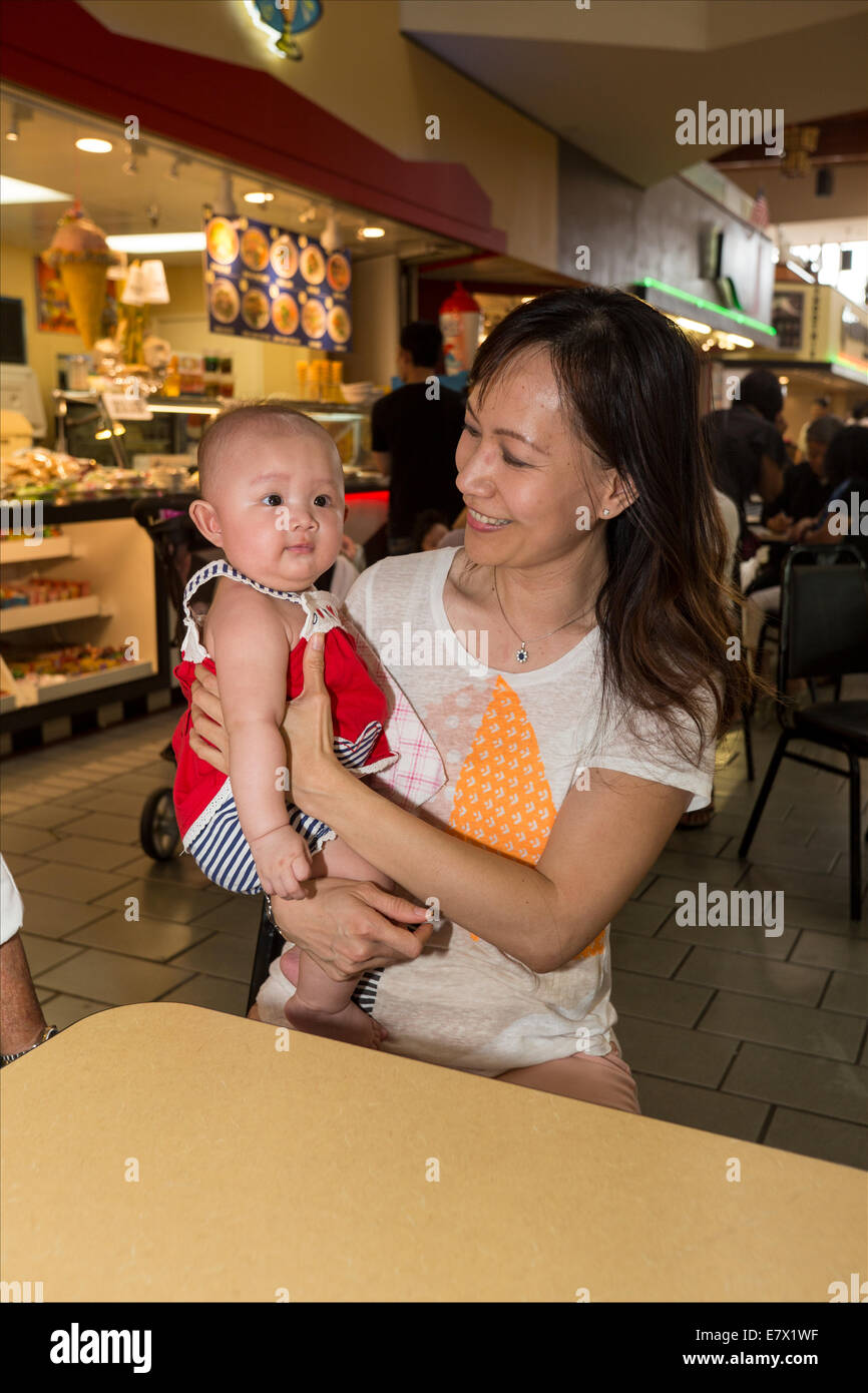 Vietnamese-Americans, Vietnamese-Americans, mother holding baby daughter, Asian Garden Mall, city of Westminster, Orange County, California Stock Photo