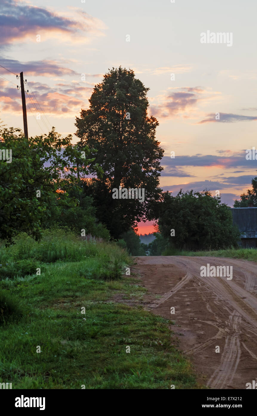 Sunrise fog over village sand road Stock Photo - Alamy