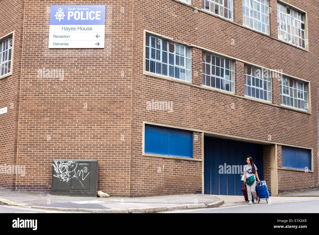 A Student walking past South Yorkshire police station near Sheffield University accommodation in Sheffield Stock Photo