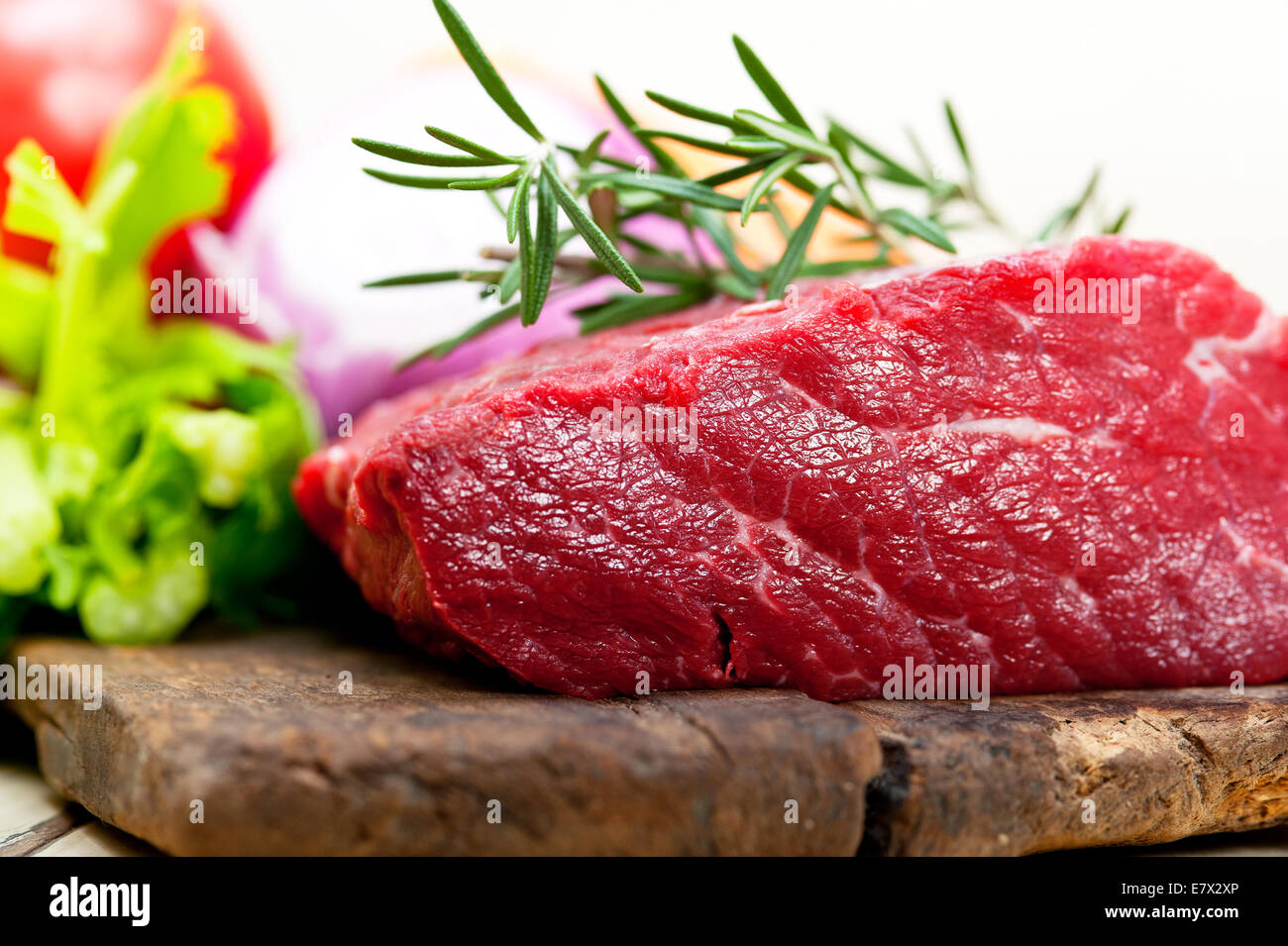 fresh raw beef cut ready to cook with vegetables and herbs Stock Photo