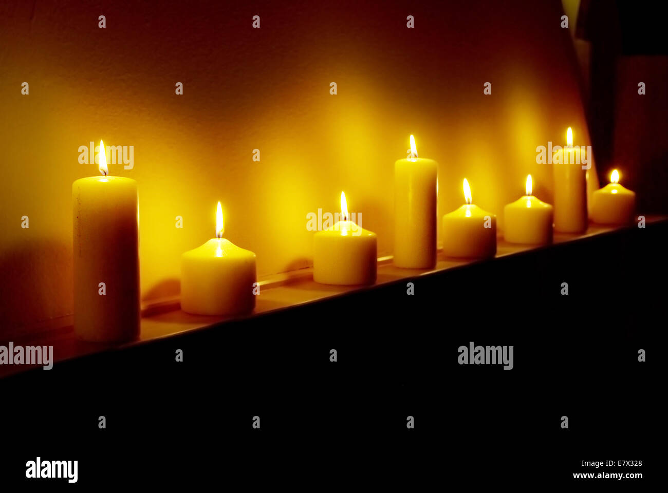 Eight candles of hope shining in the dark Stock Photo Alamy