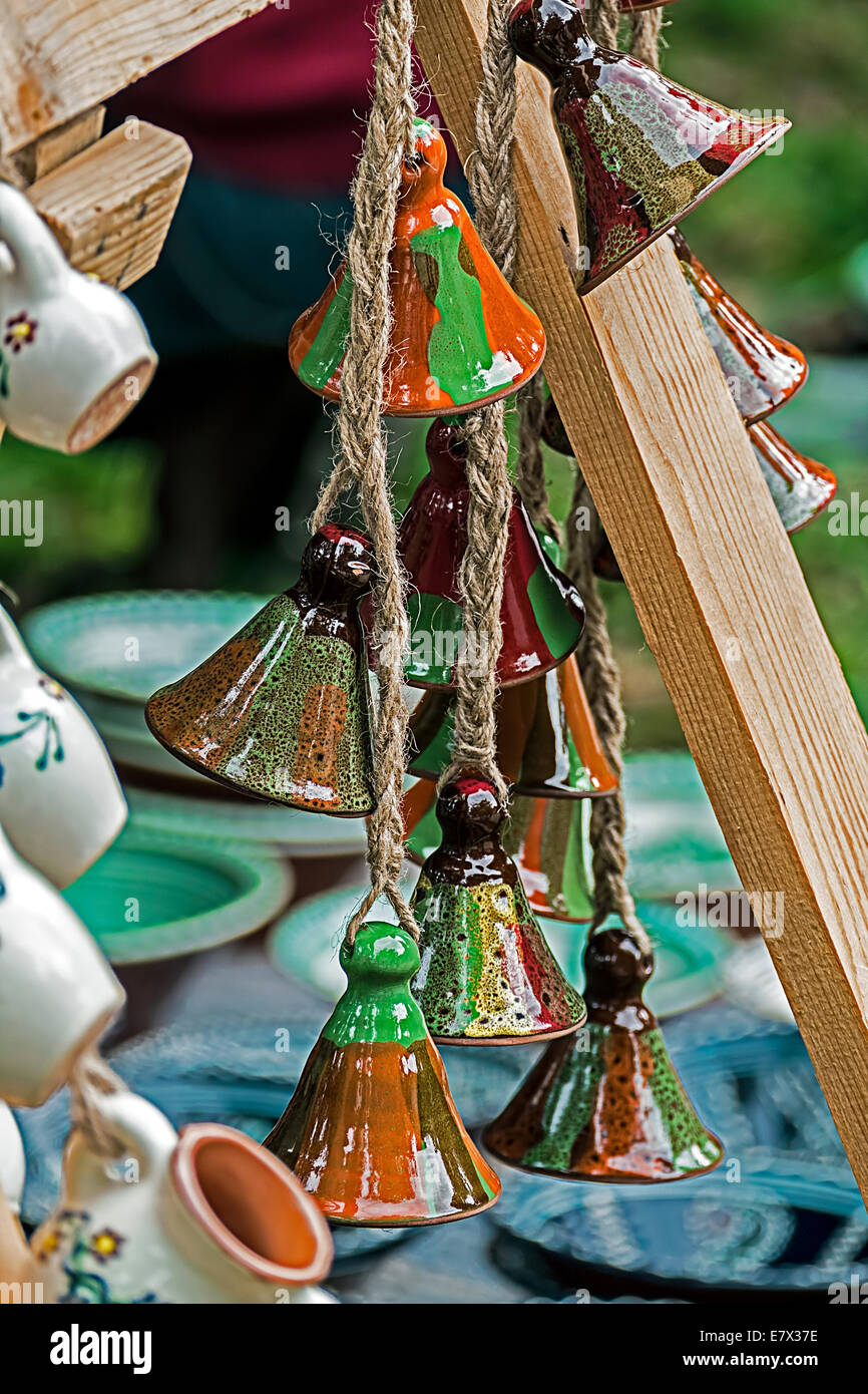 Ceramic bell hanging from a rope and exposed for sale. Stock Photo