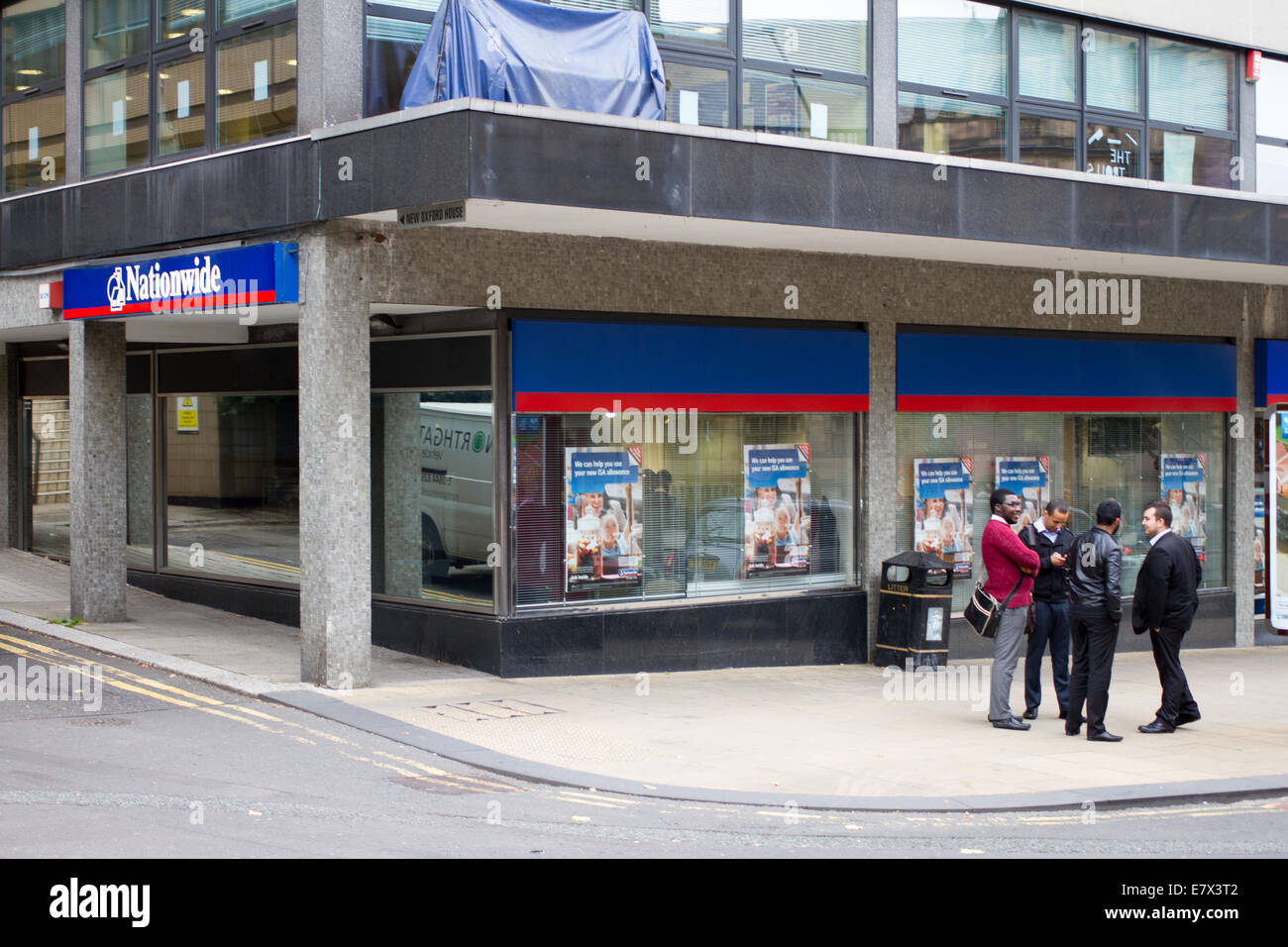 A group of men standing outside Nationwide building society in Sheffield South Yorkshire Stock Photo
