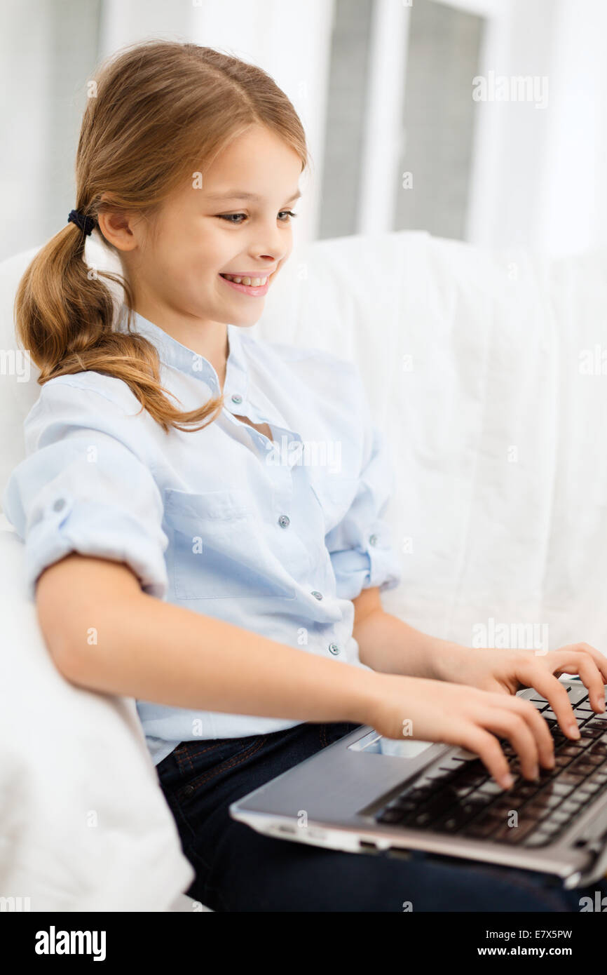 smiling girl with laptop computer at home Stock Photo - Alamy