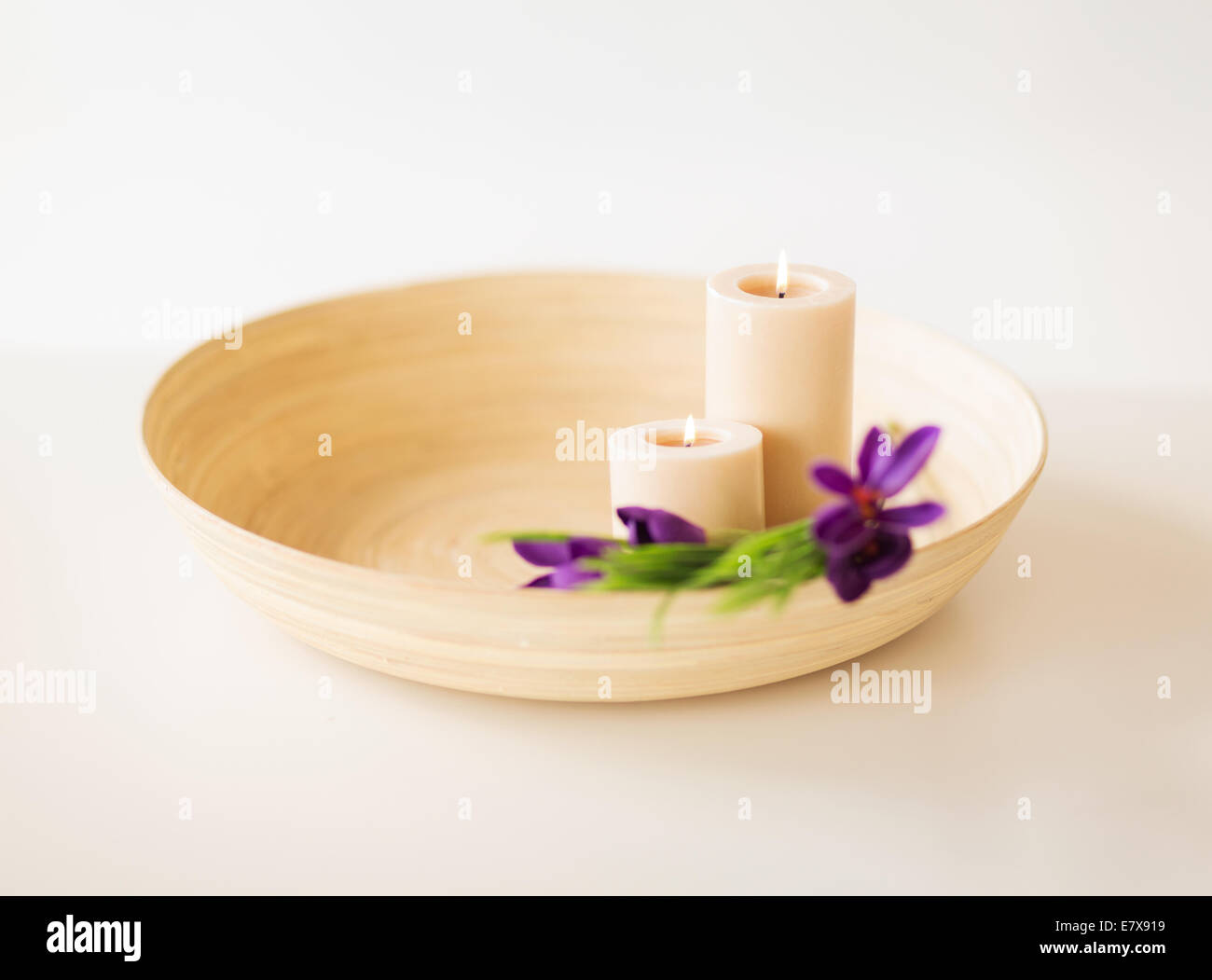 candles and iris flowers in wooden bowel Stock Photo