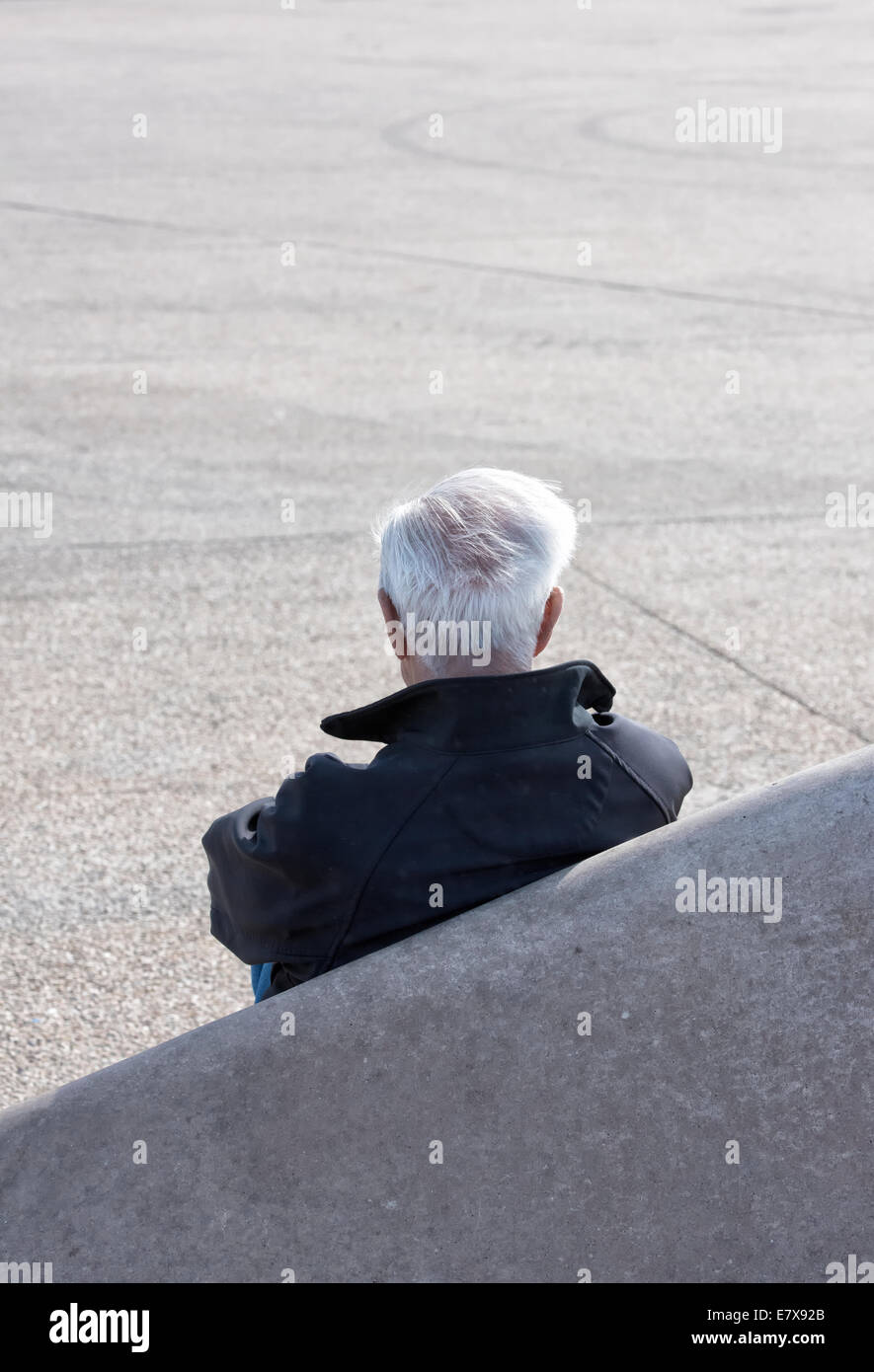 Older man sitting alone Stock Photo