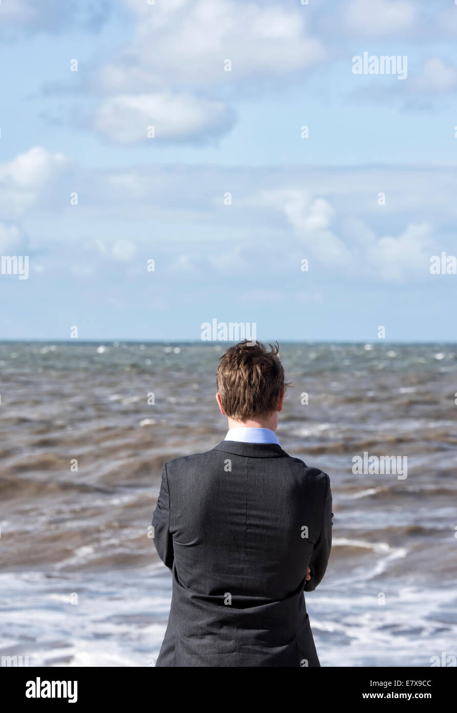 Young man looking out to sea Stock Photo