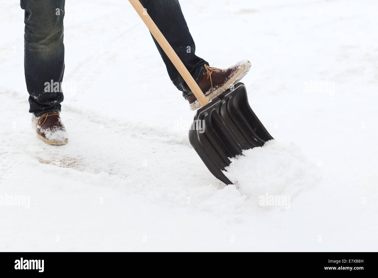 closeup of man shoveling snow from driveway Stock Photo Alamy
