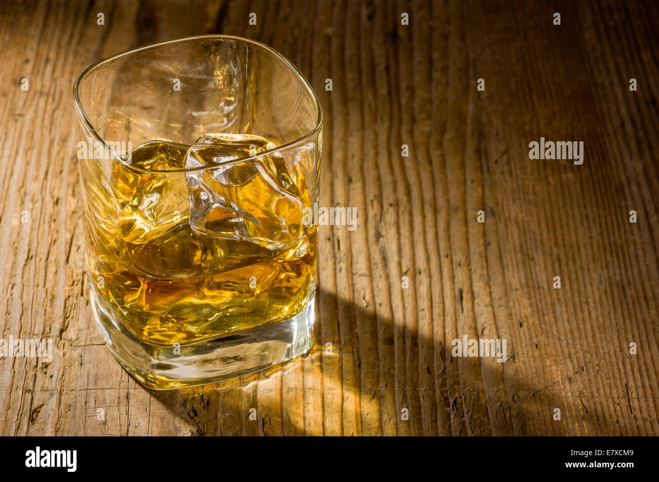 Whiskey on the rocks on a wooden background Stock Photo - Alamy