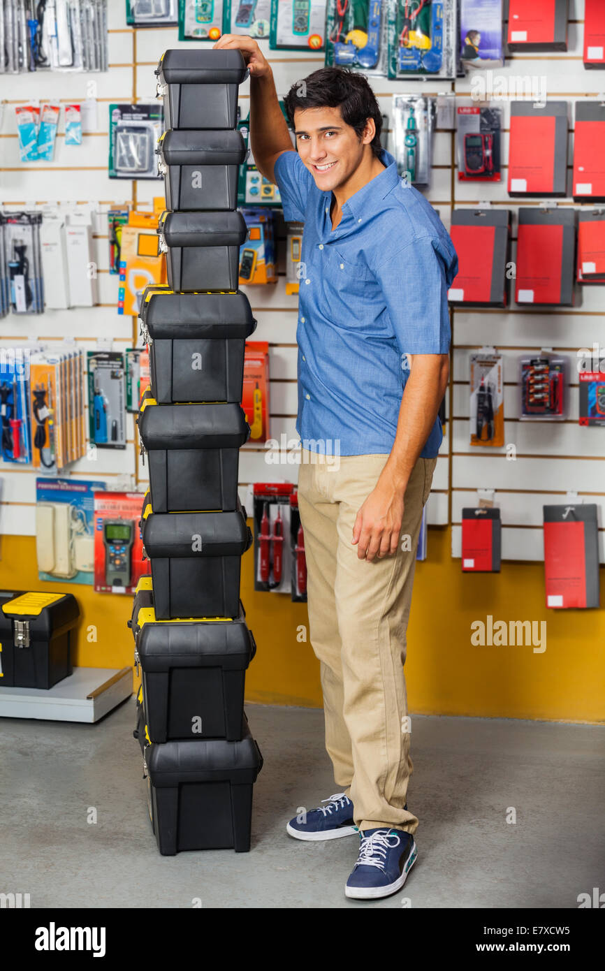 Man With Stacked Toolboxes In Hardware Store Stock Photo