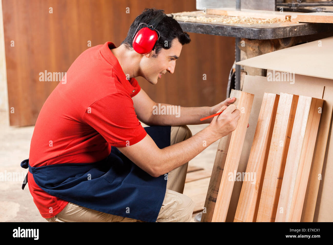 Carpenter Marking On Plank With Pencil Stock Photo Alamy