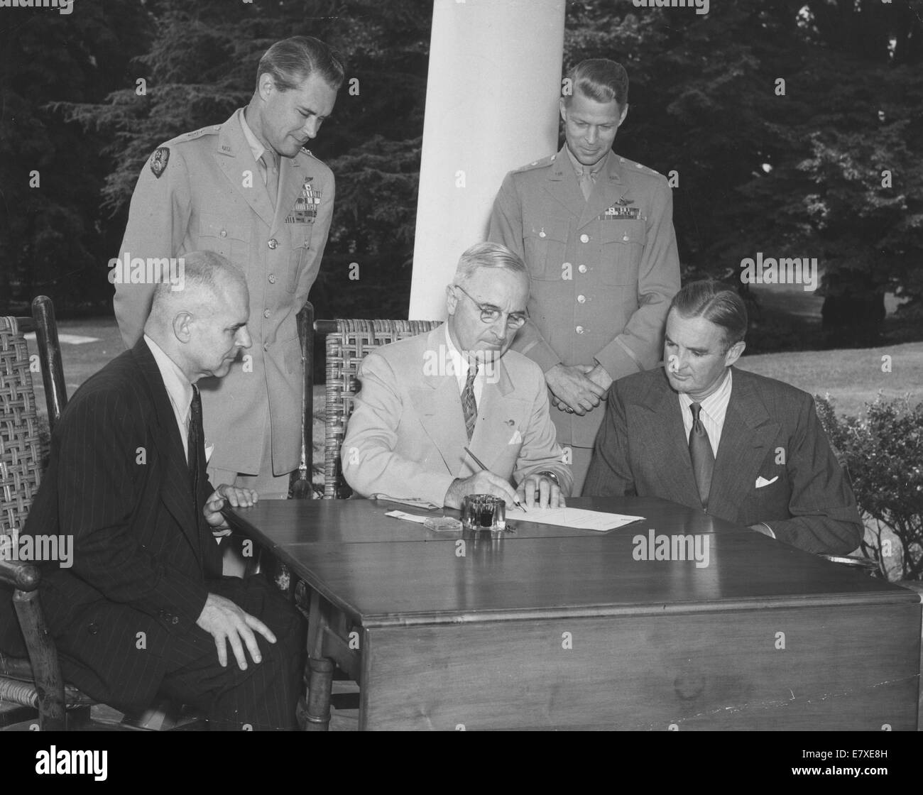 Aug 10, 1943 - Washington, District of Columbia, U.S. - President HARRY S. TRUMAN (C) signs a proclamation marking August 1st, 1947, the 40th birthday of the AAF, as Air Force Day, at a White House ceremony on the 10th, witnessed by former Lieutenant General JAMES H. DOOLITTLE (L), president of the Air Force Association; W. STUART SYMINGTON (R), Assistant Secretary of War for Air; Major General LAURIE NORSTAD (2nd R) and Director of Plans and Operations Division of the War Department General Staff; and Lieutenant General HOYT S. VANDENBERG (2nd L), Deputy Commander of the AAF. Observances from Stock Photo