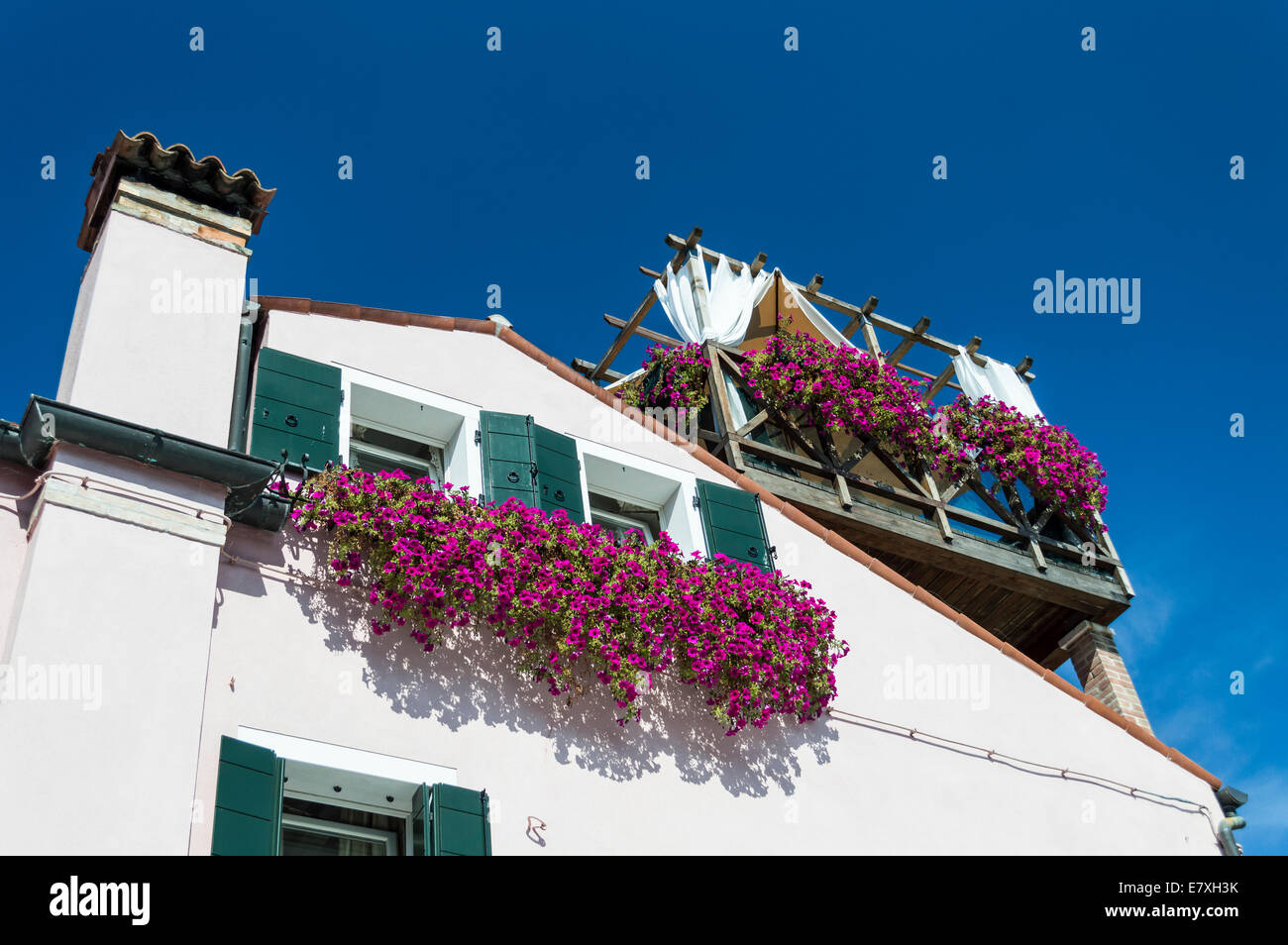 House Facade with balconies full of flowers in Torcello ,Venice, Italy Stock Photo
