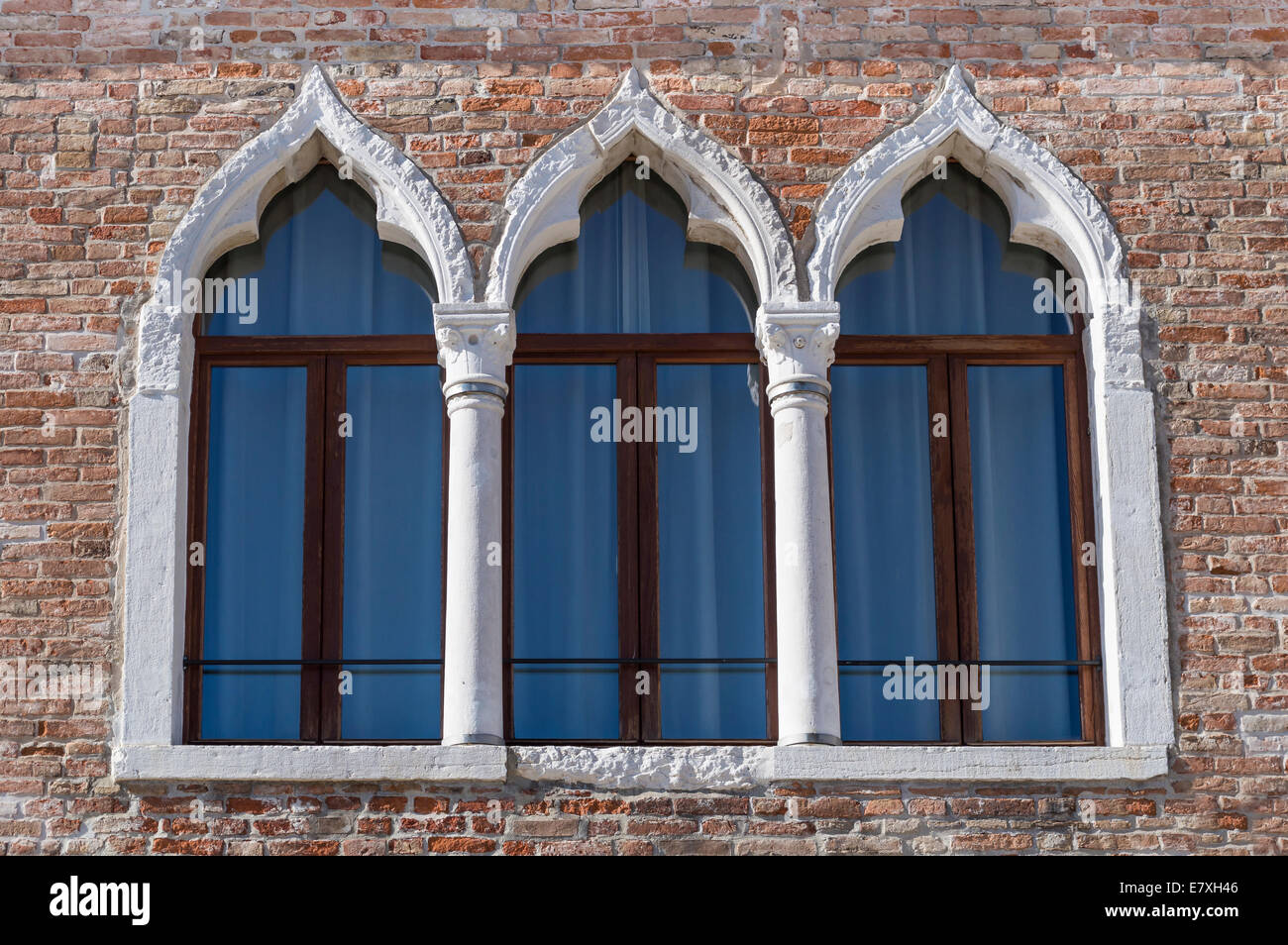 Trio of ancient arched windows typical of Venice Stock Photo