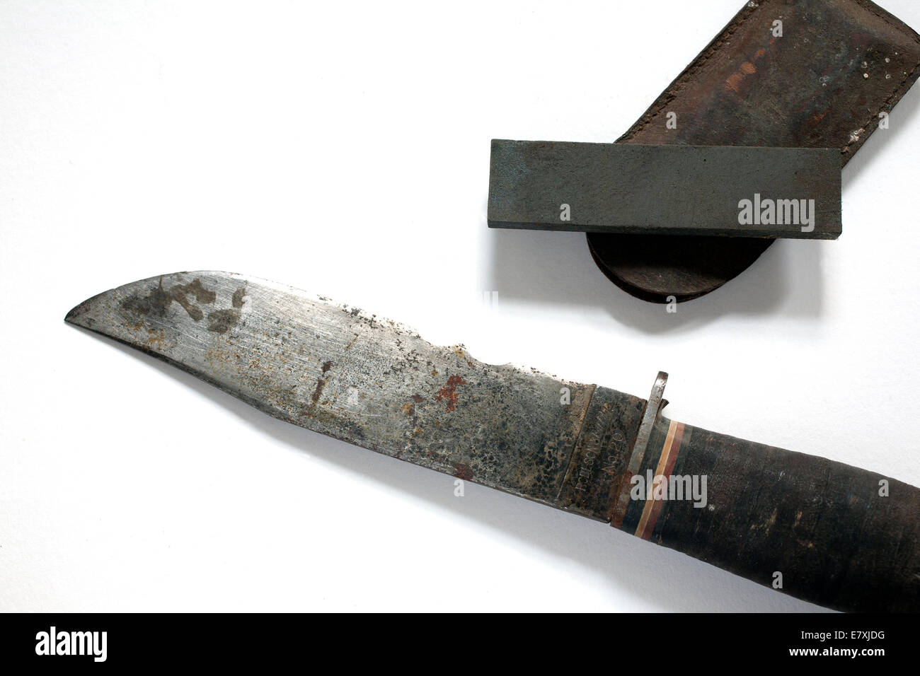 An antique WWII Navy knife and  sharpening stone with leather case. Stock Photo