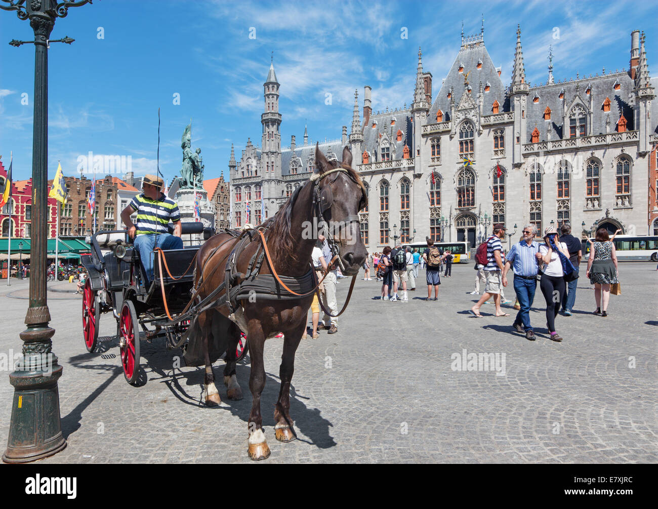 BRUGGE, BELGIUM - JUNE 13, 2014: The Carriage on the Grote Markt and the Provinciaal Hof building in background. Stock Photo