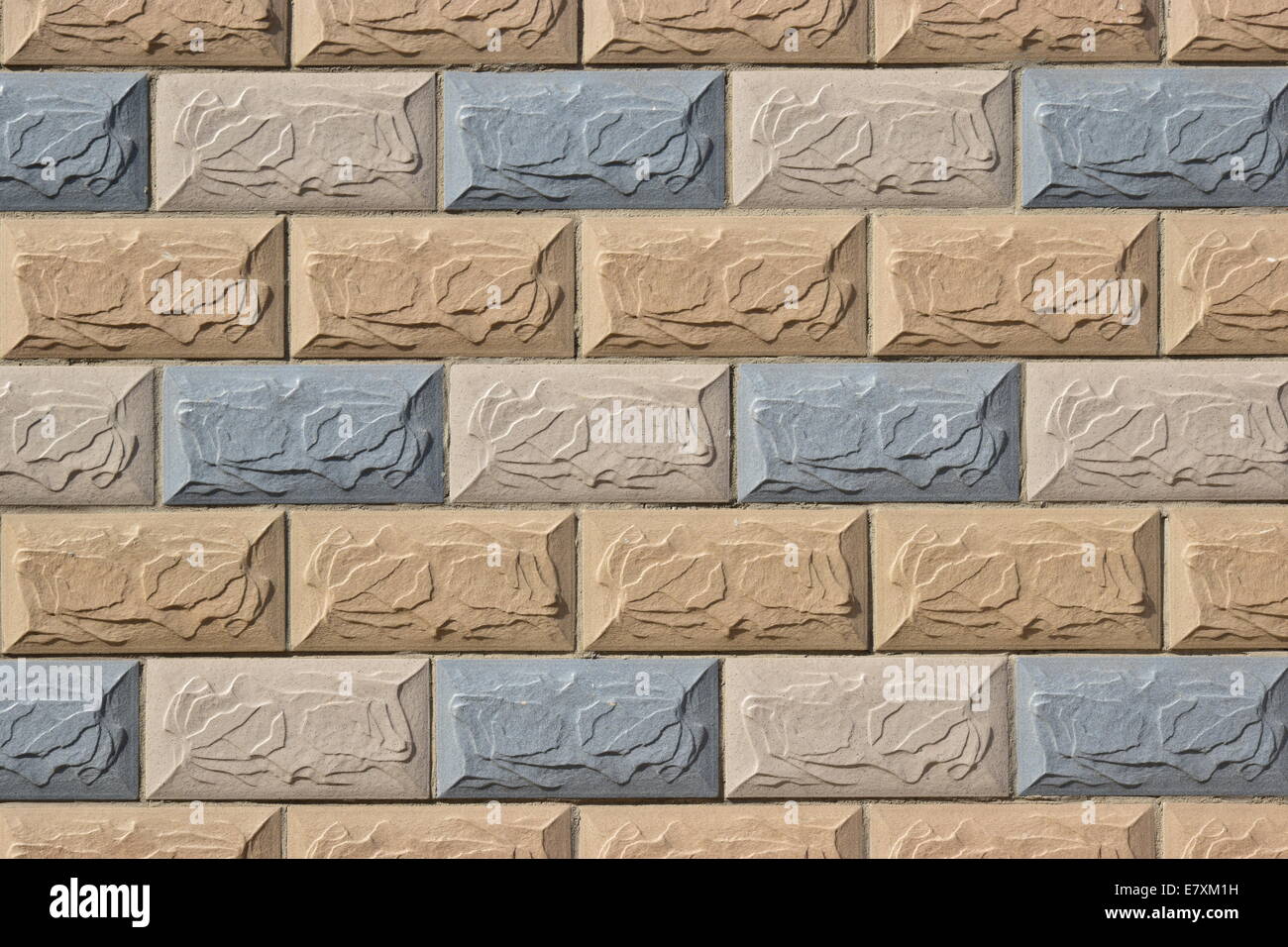 Decorative wall with reddish, blueish, and yellowish stones Stock Photo