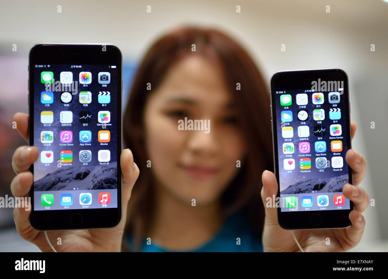 Taipei. 26th September, 2014.  A staff member displays new iPhone 6 smartphones at an Apple premium reseller's shop in Taipei, southeast China's Taiwan, early Sept. 26, 2014. Apple's iPhone 6 and iPhone 6 Plus went on sale on Friday in Taiwan. Credit:  Wang Qingqin/Xinhua/Alamy Live News Stock Photo