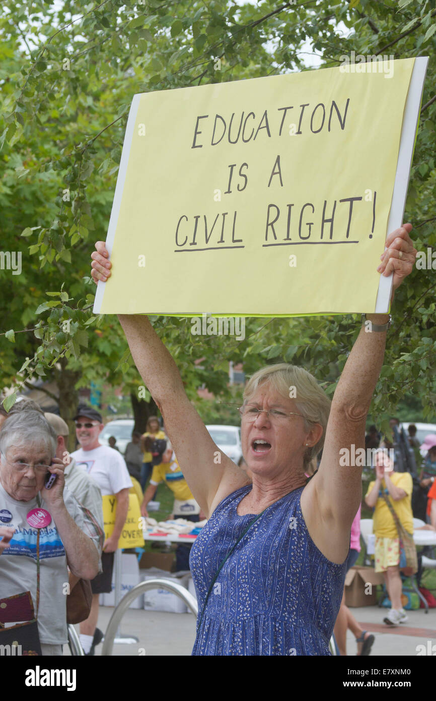 Asheville, North Carolina, USA - August 4, 2014:  Woman holds sign saying "Education is a civil right!" at a Moral Monday rally Stock Photo