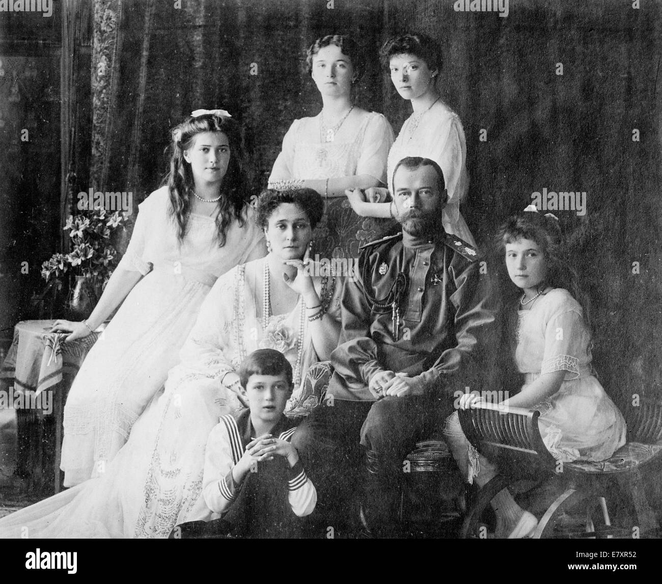 Royal Russian family - members of the Romanovs, the last royal family of Russia including: seated (left to right) Marie, Queen Alexandra, Czar Nicholas II, Anastasia, Alexei (front), and standing (left to right), Olga and Tatiana, circa 1914 Stock Photo