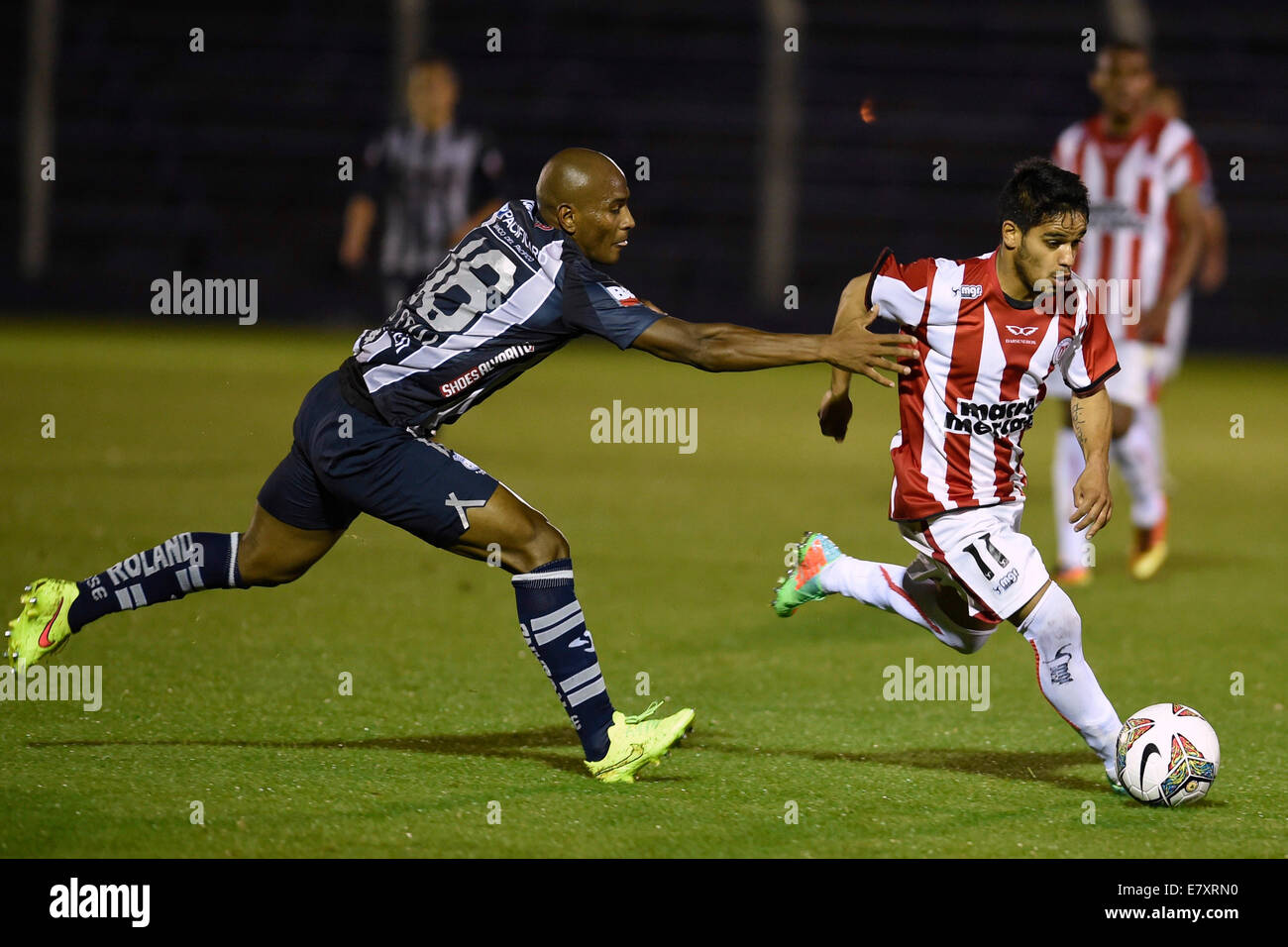 Montevideo, Uruguay. 25th Sep, 2014. Cristian Techera (R) of Uruguay's River Plate vies for the ball with Oscar Bagui of Ecuador's Emelec during their Copa Sudamericana soccer match, held at Luis Franzini stadium, in Montevideo, capital of Uruguay, on Sept. 25, 2014. Credit:  Nicolas Celaya/Xinhua/Alamy Live News Stock Photo