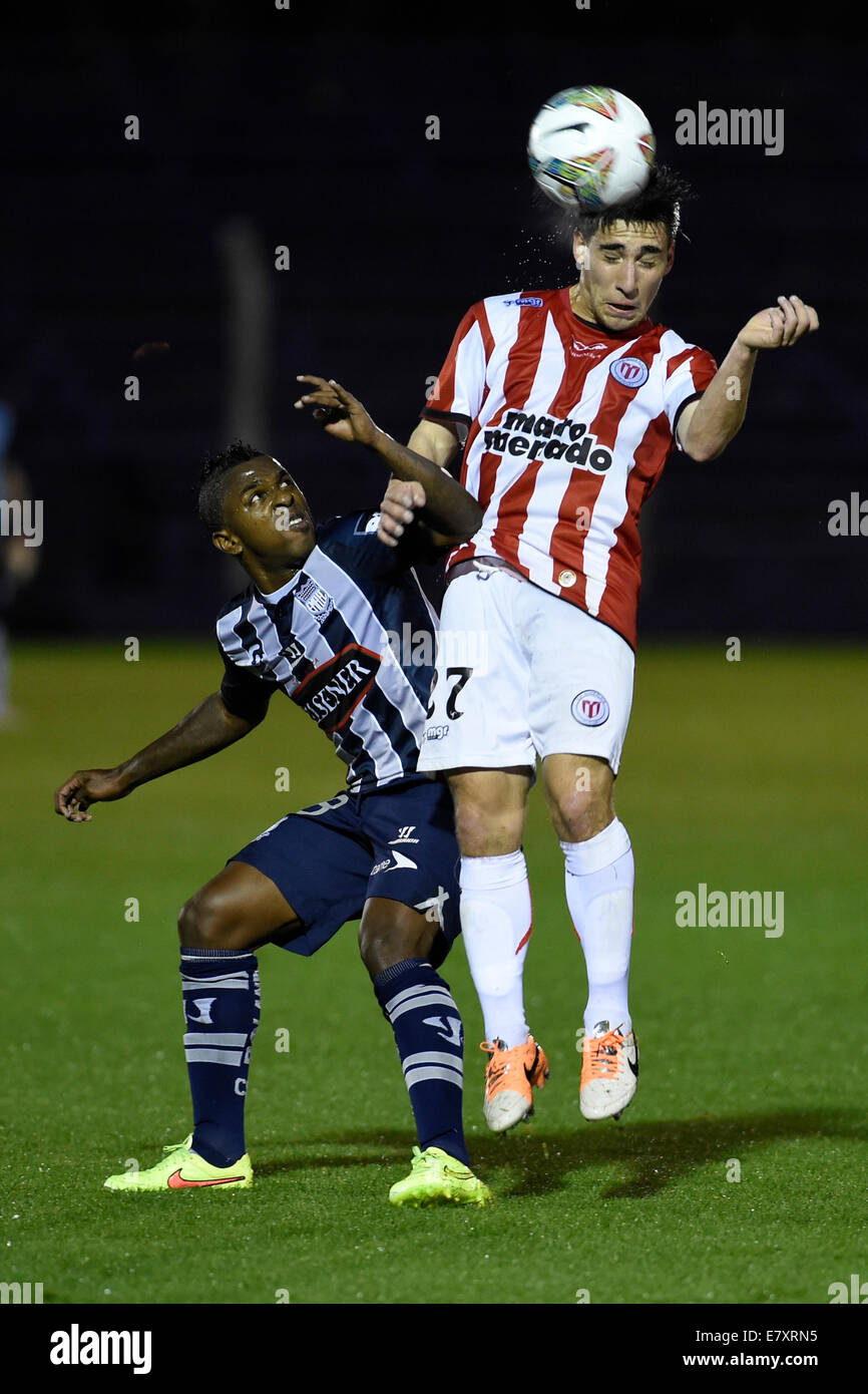 Montevideo, Uruguay. 25th Sep, 2014. Fernando Gorriaran (R) of Uruguay's River Plate vies for the ball with Gabriel Achilier of Ecuador's Emelec during their Copa Sudamericana soccer match, held at Luis Franzini stadium, in Montevideo, capital of Uruguay, on Sept. 25, 2014. Credit:  Nicolas Celaya/Xinhua/Alamy Live News Stock Photo