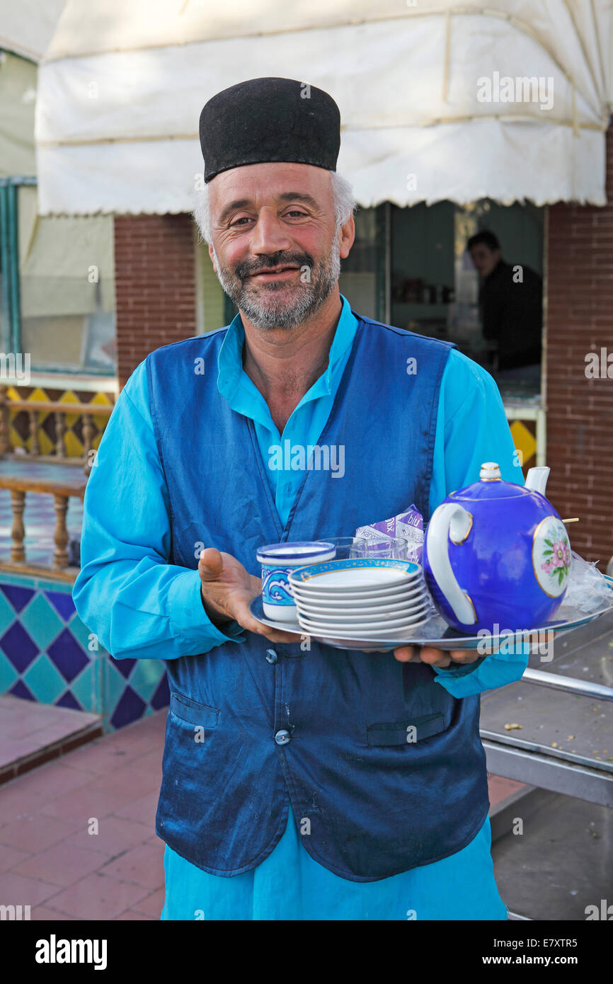 Waiter serving tea in a traditional restaurant, Bazaar, Isfahan, Isfahan Province, Persia, Iran Stock Photo