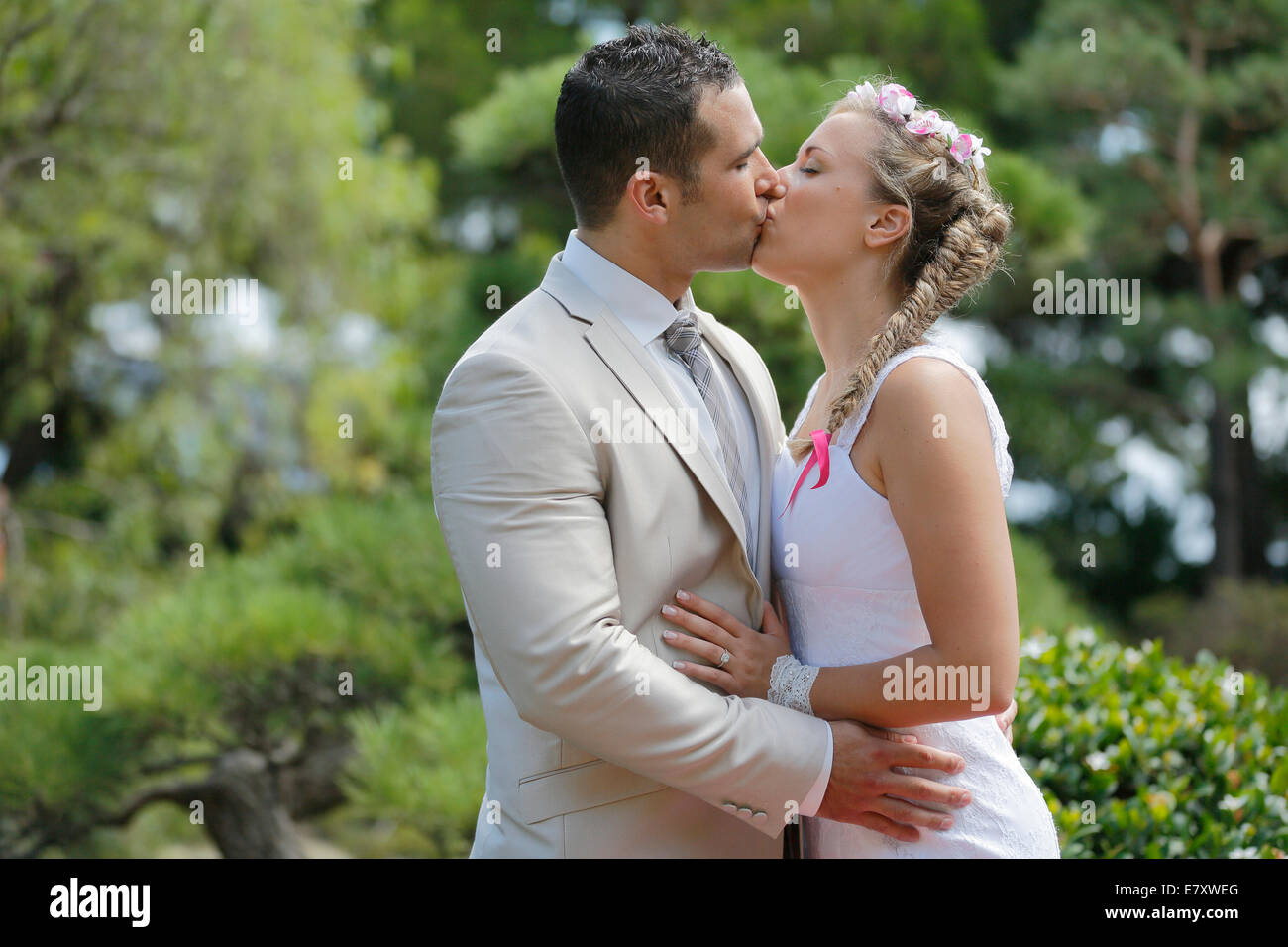 Newlyweds kissing while exiting the church after wedding ceremony, family  and friends celebrating their love with the shower of soap bubbles, custom  Stock Photo - Alamy