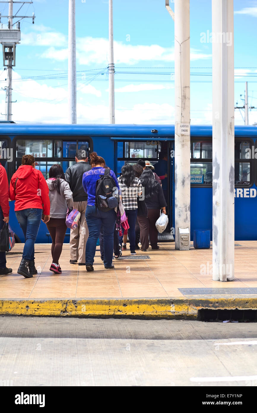 Unidentified people getting into a bus of the local public transportation system in Quito, Ecuador Stock Photo