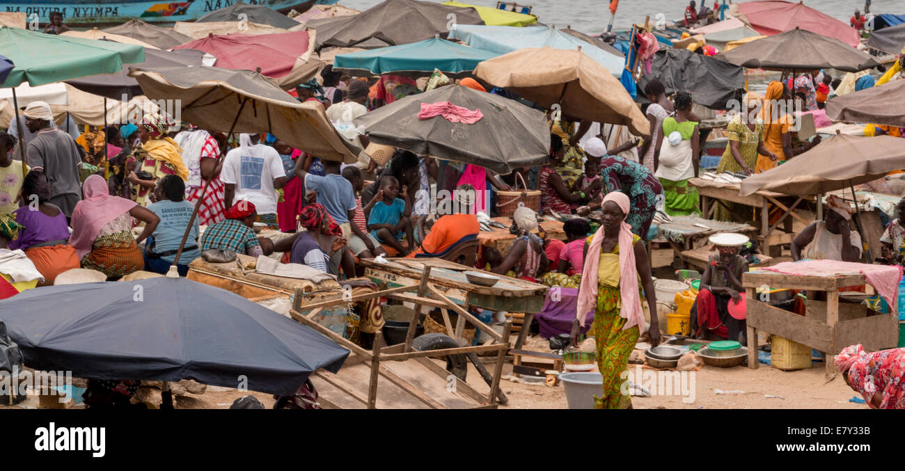Mbour, Senegal - July, 2014: Several hundred people come together at the local fish market in Mbour to buy and sell the daily ca Stock Photo