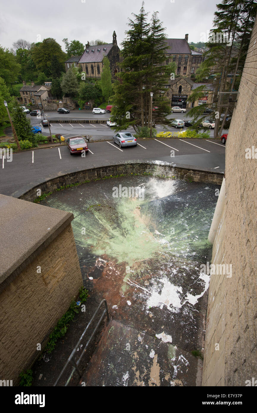 High view of criminal damage or vandalism caused by paint dropped & splattered outside in car park by vandals - Baildon, West Yorkshire, England, UK. Stock Photo