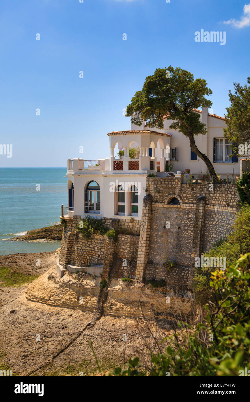 Single imposing house overlooks the calcareous rocks and sea of the Charente Maritime France. Stock Photo