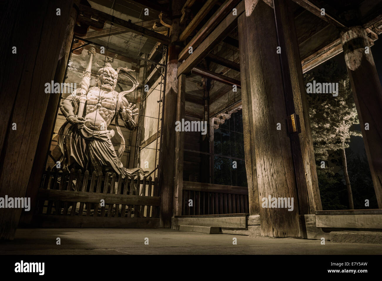 Night view of the huge wooden Agyõ gate guardian statue in the