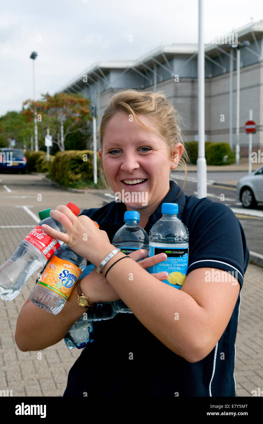 Bristol, UK. 26th Sep, 2014. Local resident Charlotte Weeks at Longwell Green getting water in lots of small bottles after being left with no water overnight due to a burst water mains in Fisher Road, Kingswood, Bristol, which is affecting thousands in East Bristol.  Bristol water have no estimated time when service will be restored. Taken 10.30am Sept 26th. Credit:  Rachel Husband/Alamy Live News Stock Photo