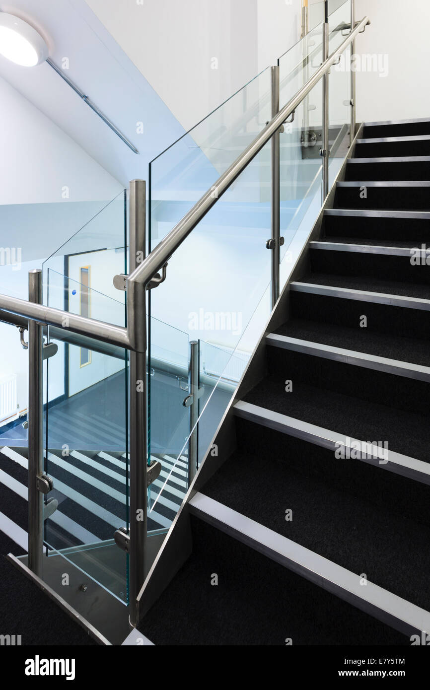 Modern staircase witt stainless steel hand rails. Stock Photo