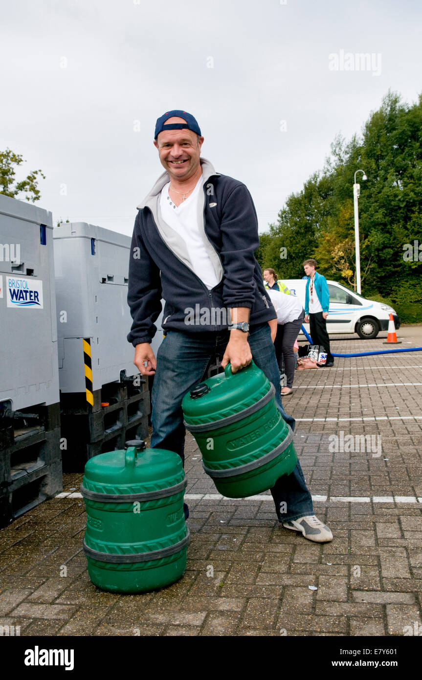 Bristol, UK. 26th Sep, 2014. Local resident Darren Oldfield in Longwell Green getting water after being left with no water overnight due to a burst water mains in Fisher Road, Kingswood, Bristol, which is affecting thousands in East Bristol.  Bristol water have no estimated time when service will be restored. Taken 10.30am Sept 26th. Credit:  Rachel Husband/Alamy Live News Stock Photo
