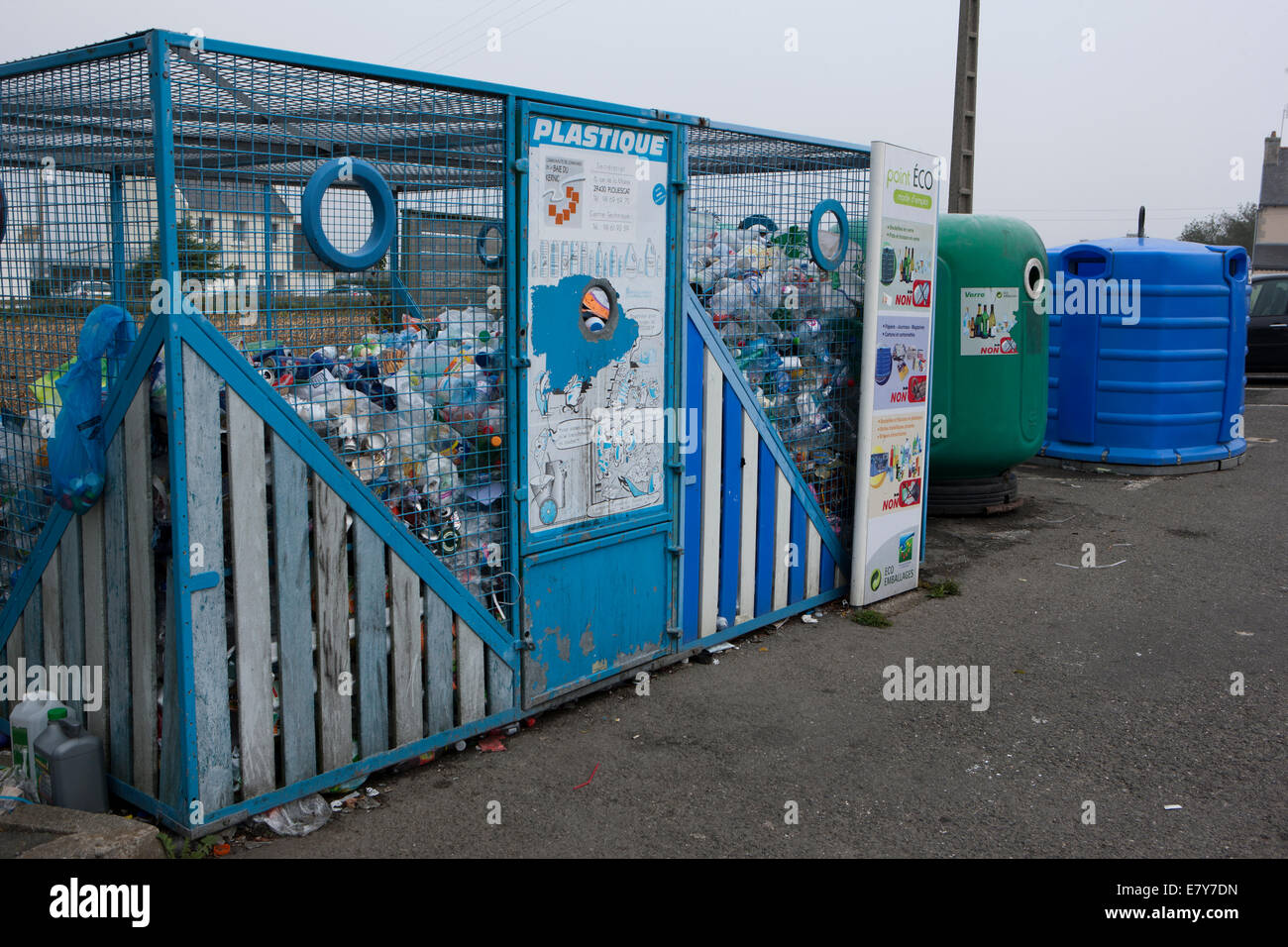 Recycling containers in a Car Park in the town of Plouescat, Brittany, France Stock Photo