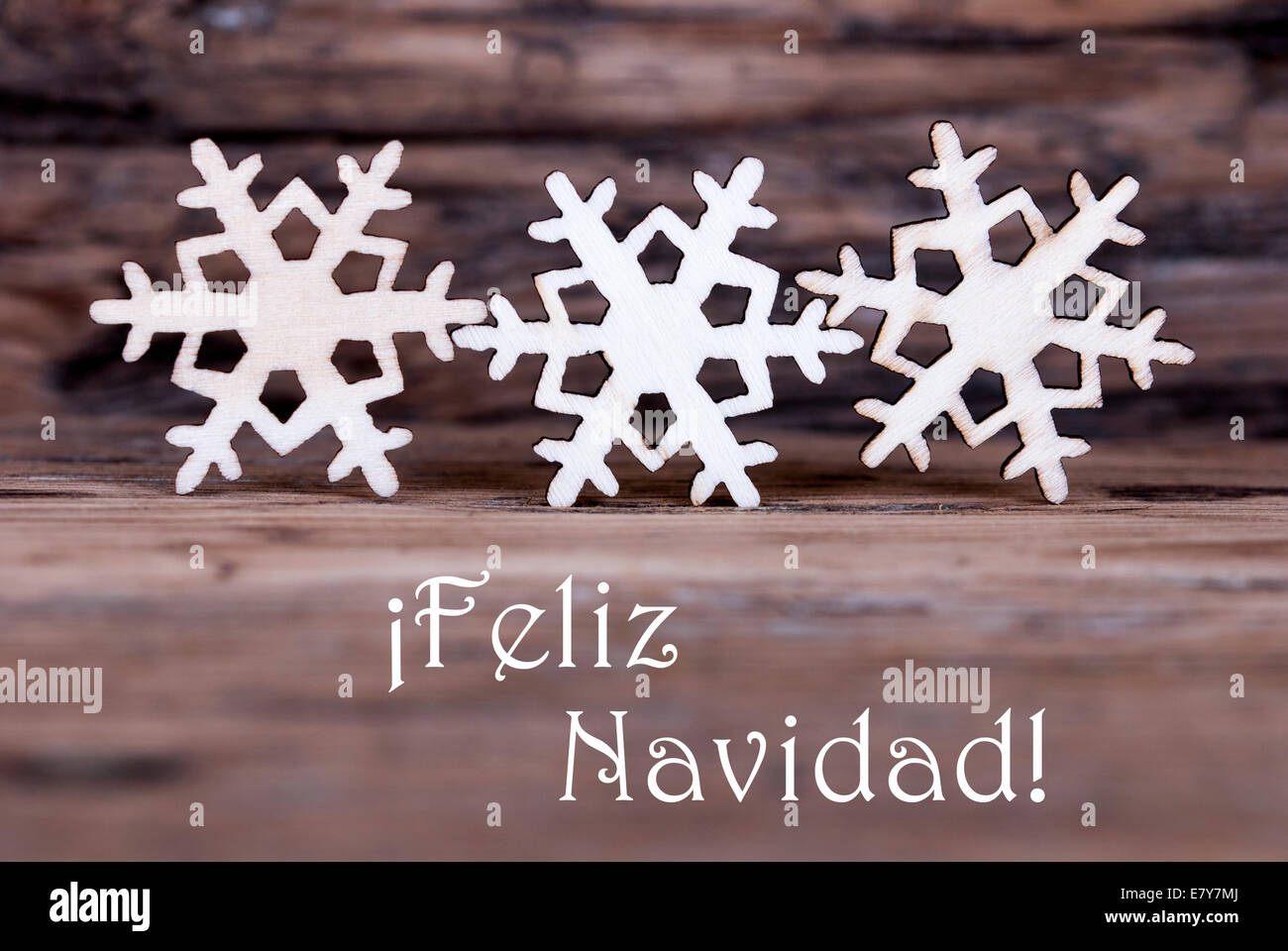 Three Snowflakes with the Spanish Words Feliz Navidad which means Merry Christmas Stock Photo