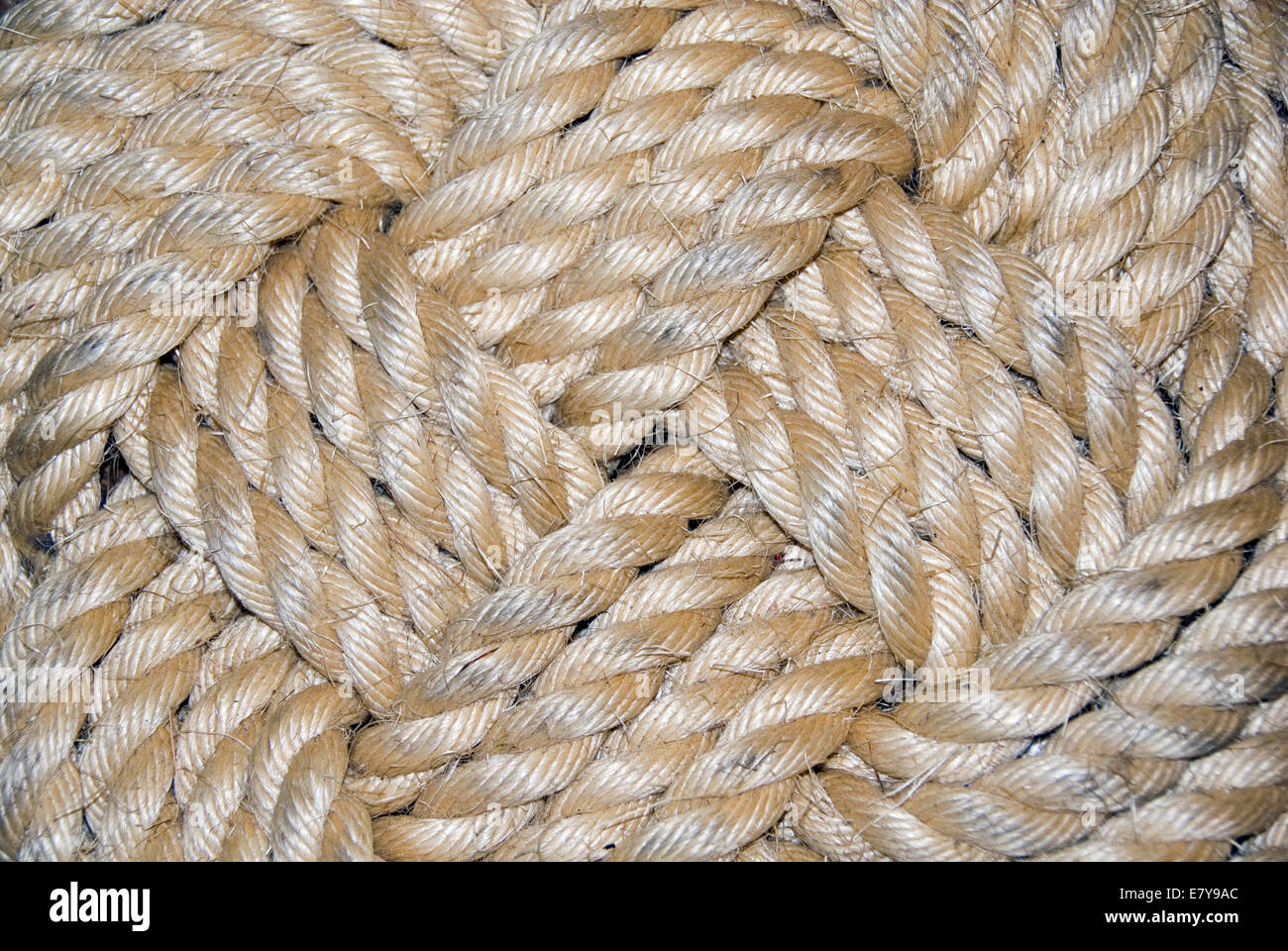 Close up on the twisted rope strands at the centre of a decorative knot called the Ocean Plait Mat, Postmouth Historic Dockyard, Stock Photo