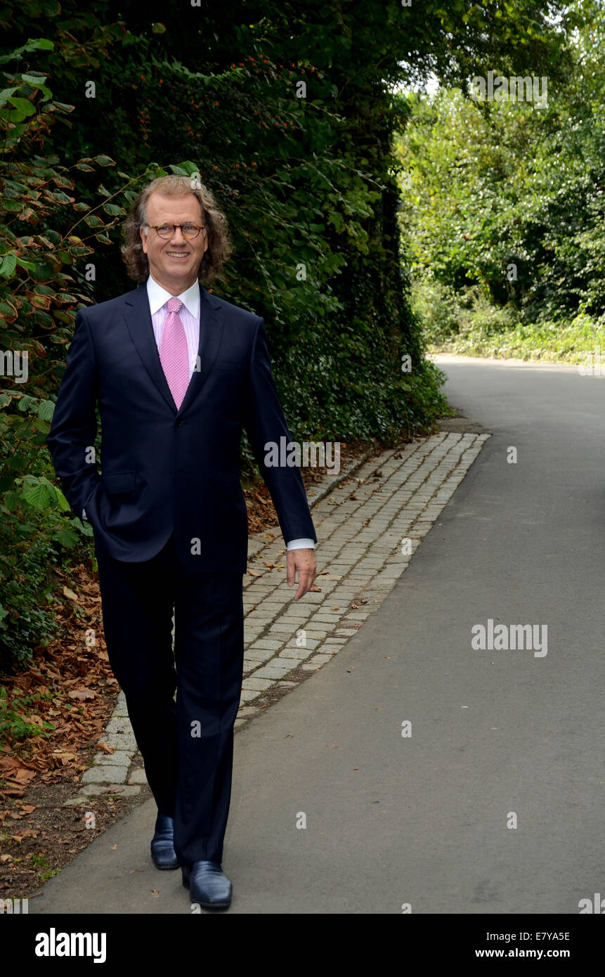 Maastricht, The Netherlands. 25th Sep, 2014. Andre Rieu walks through the inner courtyard of his castle in Maastricht, The Netherlands, 25 September 2014. The Dutch violinist and his Johannes Strauss Orchestra played excerpts of his album 'Eine Nacht in Venedig' (lit. One night in Venice) in front of international members of the press for the first time. The album will be released on 31 October 2014. Afterwards a reception was held in the castle. Rieu will celebrate his 65th birthday on 01 October and start his tour through Germany in January 2015. Photo: HORST OSSINGER/dpa/Alamy Live News Stock Photo
