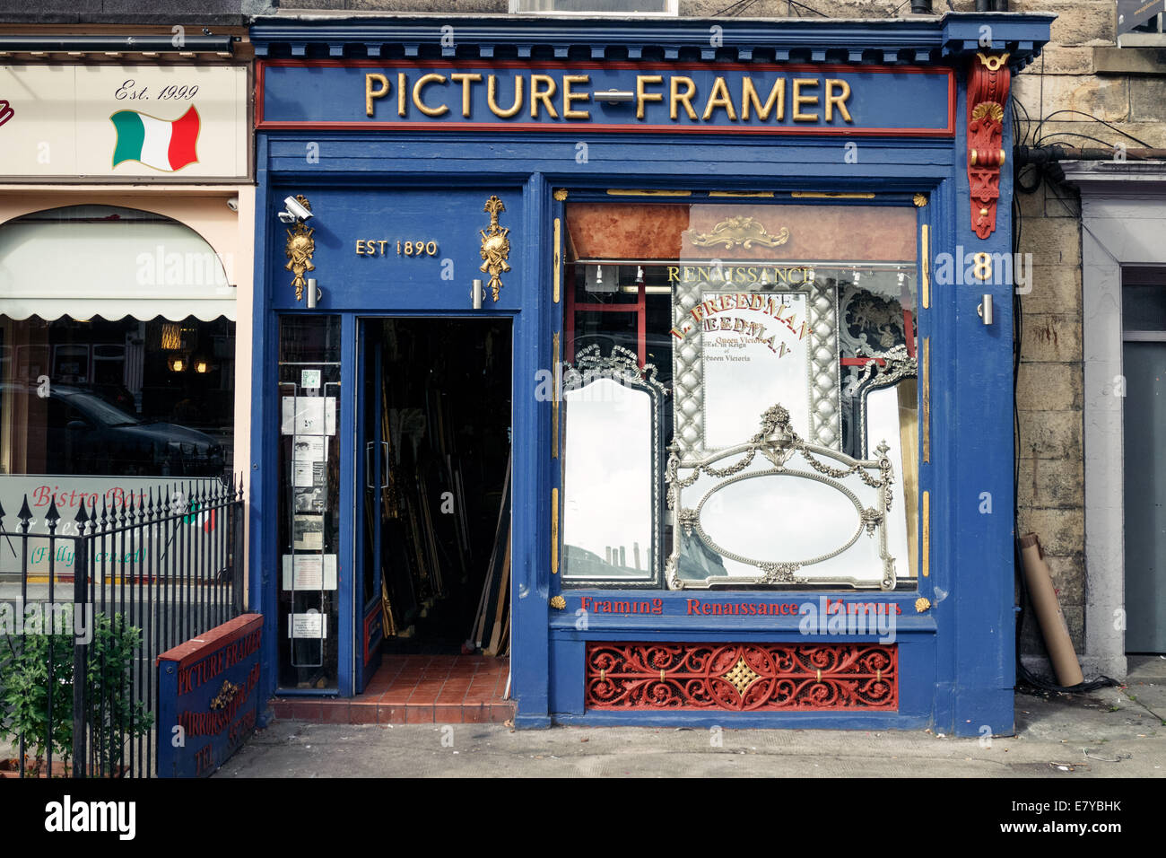 Mirrors in the window of the Picture Framers small business at the top